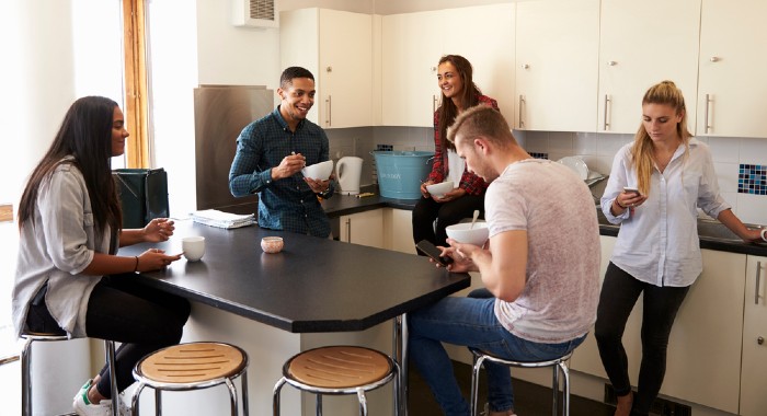 students relaxing in a kitchen