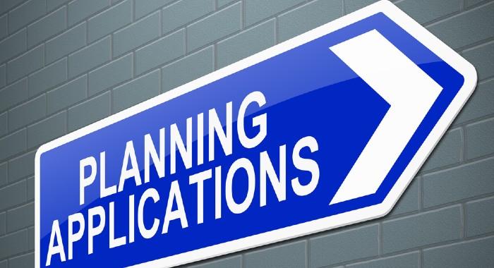 blue and white arrow sign saying: planning applications